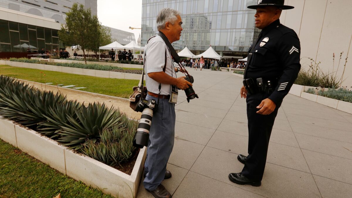 Associated Press photographer Nick Ut with an officer before a graduation ceremony at LAPD headquarters.