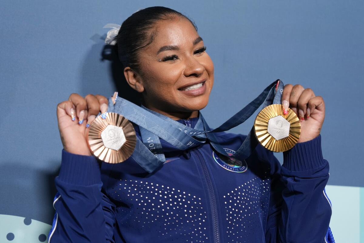 FILE - Jordan Chiles, of the United States, holds up her medals after the women's artistic gymnastics.