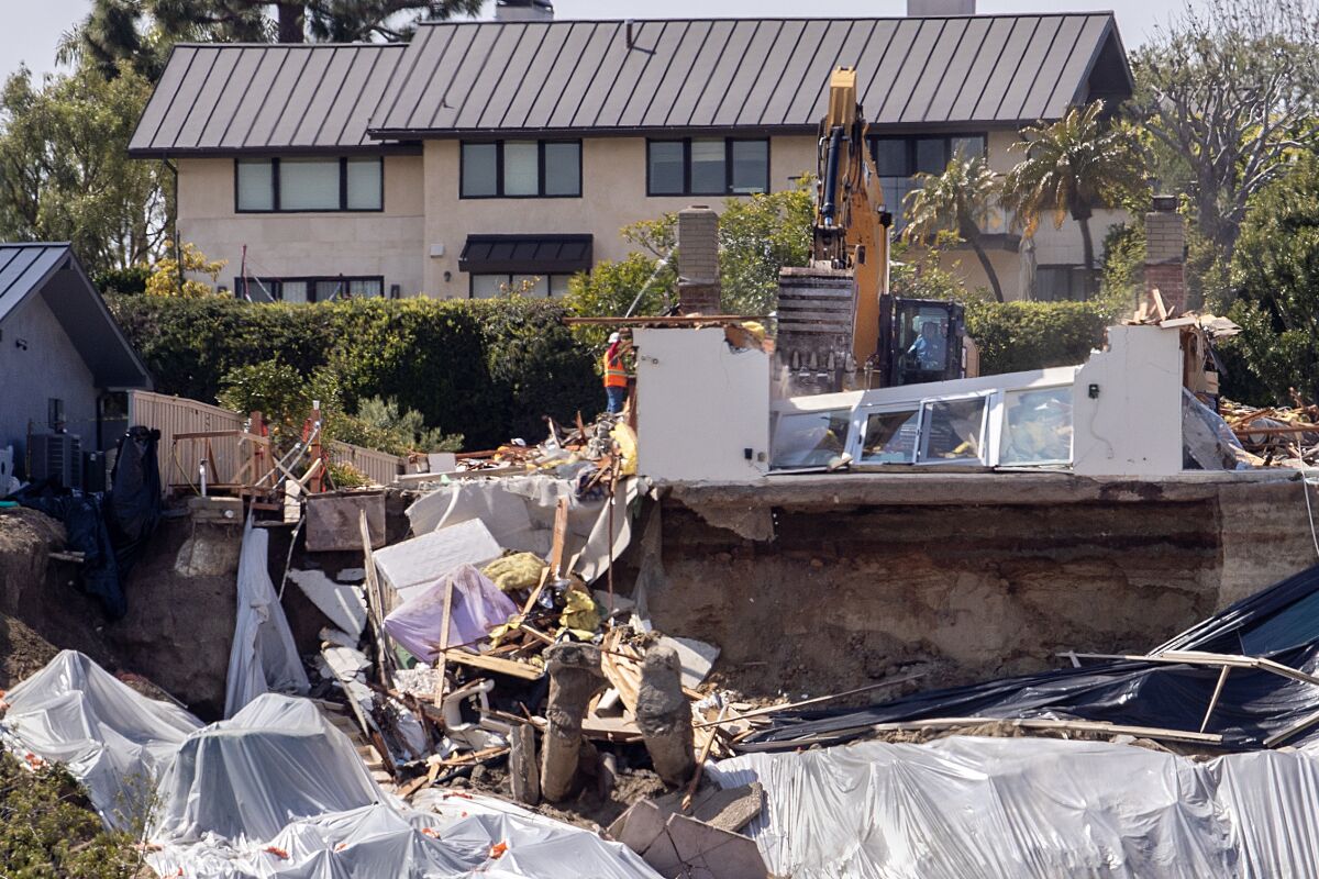 Crews demolish the final remaining wall on the home