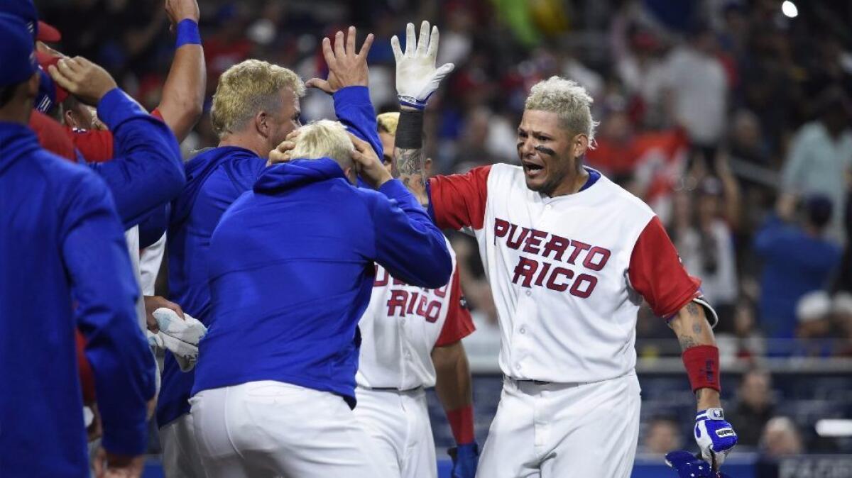 Puerto Rico catcher Yadier Molina (4) is congratulated after hitting a solo home run in the World Baseball Classic Pool F Game 1 against the Dominican Republic at PETCO Park on Mar. 14.