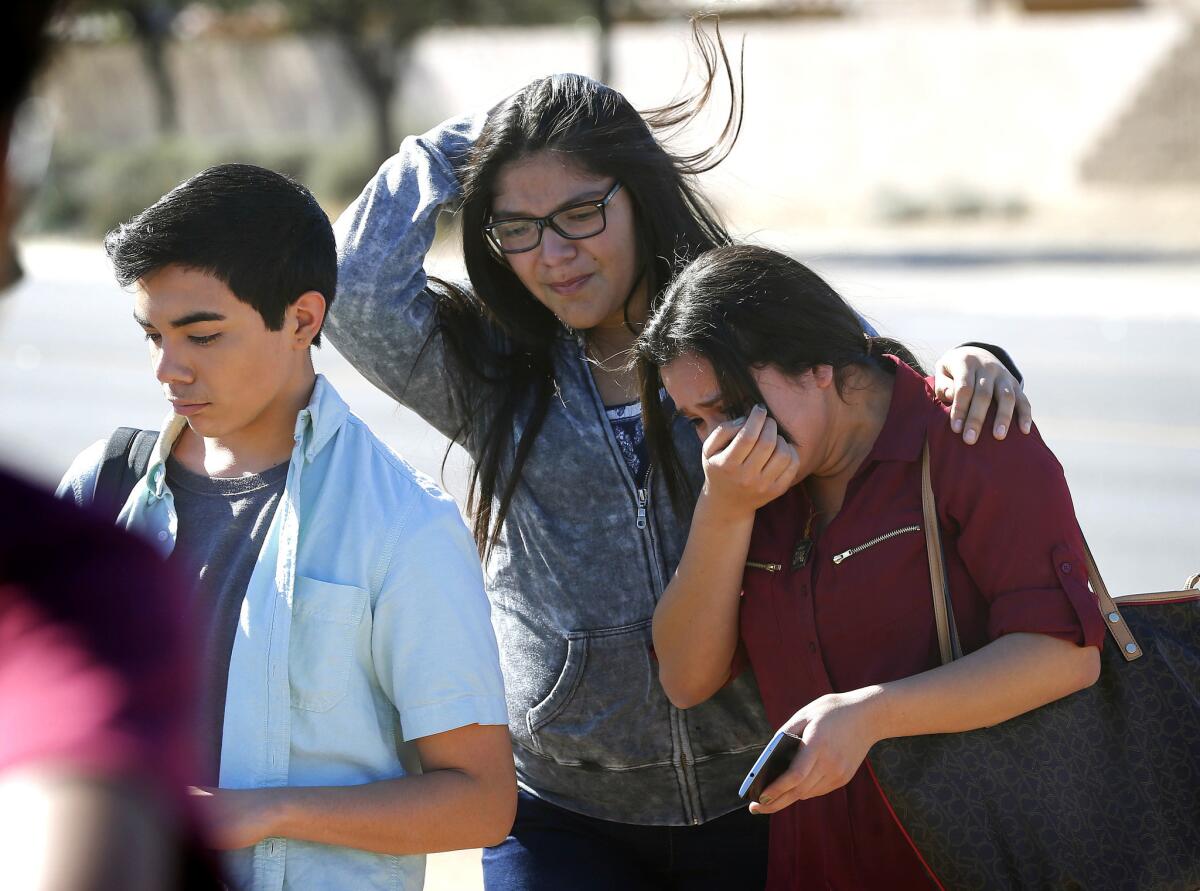 Students are released from lockdown Friday at Independence High School in Glendale, Ariz., after two students were shot and killed. The deaths appear be a murder-suicide, authorities said.
