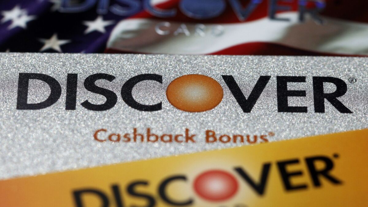 Discover Financial is shutting down a mortgage lending unit and laying off 460 employees in Irvine and Louisville, Ky. Above, the company's signature rewards cards.