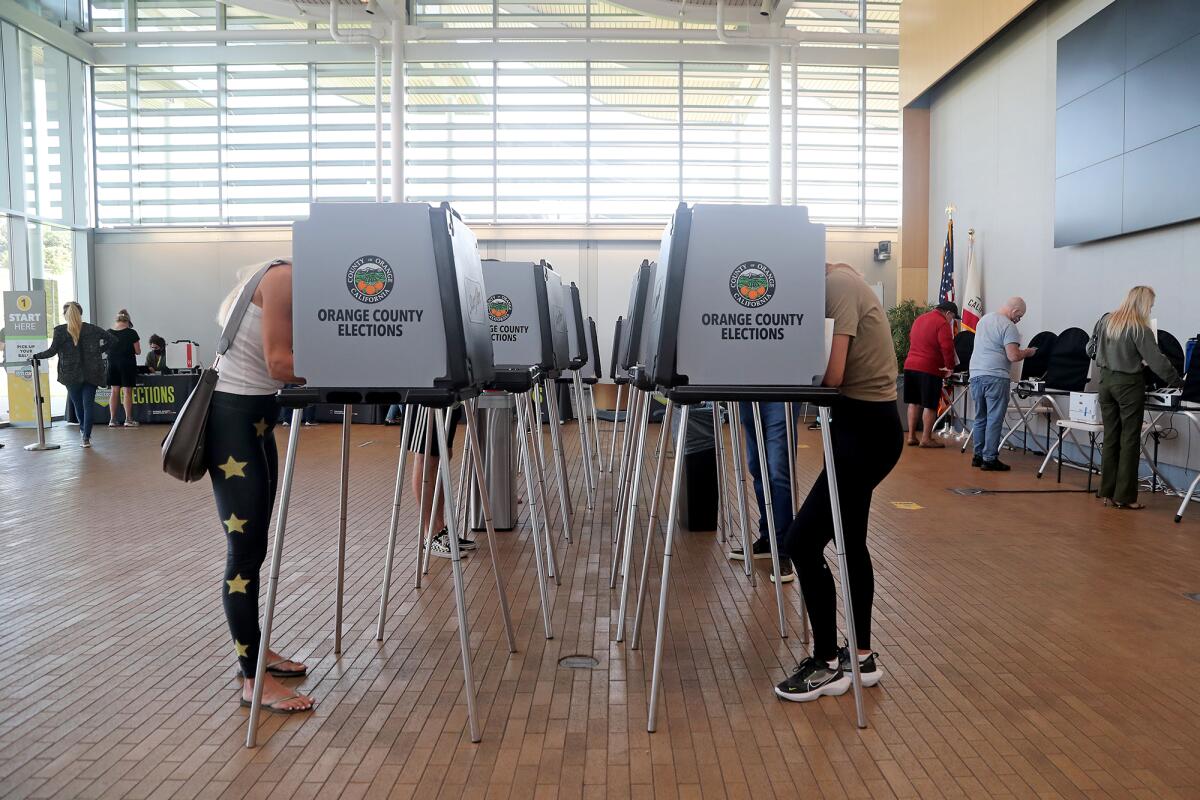 Voters make their ballot selections inside the Newport Beach Civic Center on Tuesday.