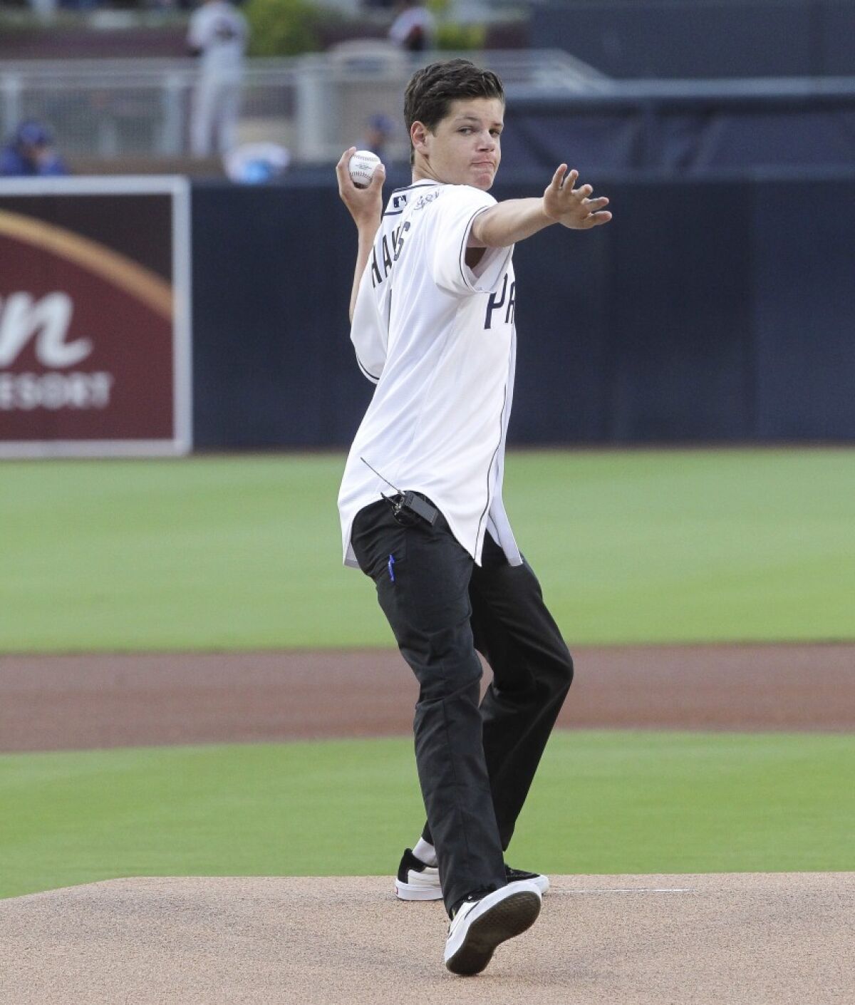 Keane Webre-Hayes has his throwing arm warmed up by his physical therapist Jon Luu before throwing the ceremonial first pitch prior to the Padres game against the Giants at Petco Park on Tuesday, July 2, 2019.