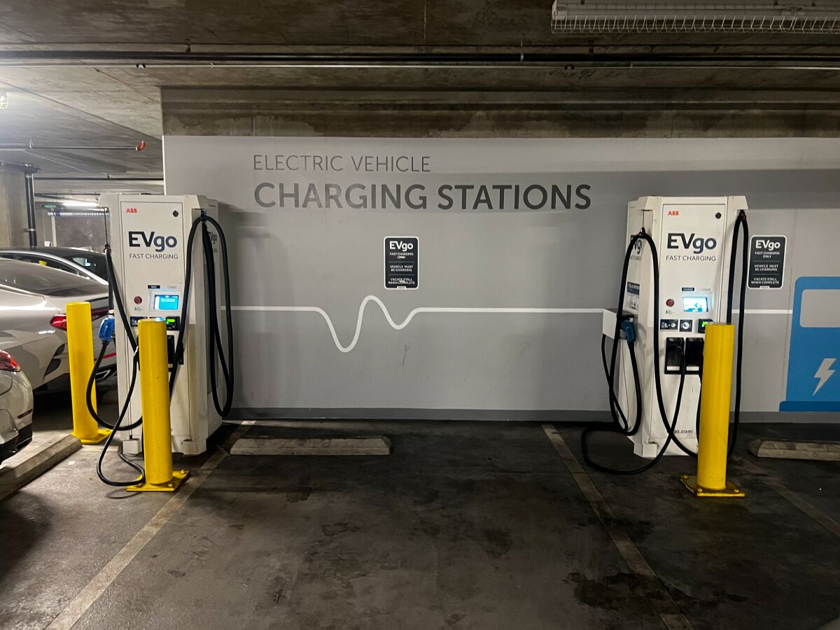 Two EV chargers are shown in a garage.