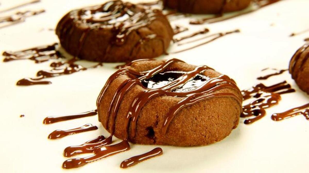 Chocolate raspberry thumbprint cookies with chocolate drizzle.