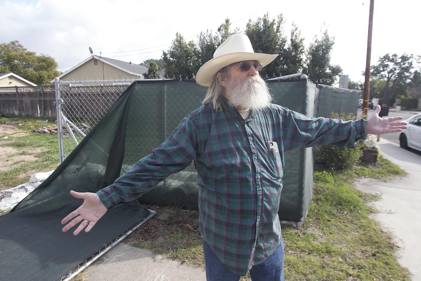 Phillip Richardson stands on what used to be his home's driveway at 276 E. 19th St., in Costa Mesa.