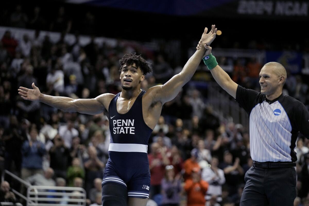 Penn State's Carter Starocci celebrates after defeating Ohio State's Rocco Welsh in their 174-pound match in the finals of the NCAA wrestling championships, Saturday, March 23, 2024, in Kansas City, Mo. (AP Photo/Charlie Riedel)