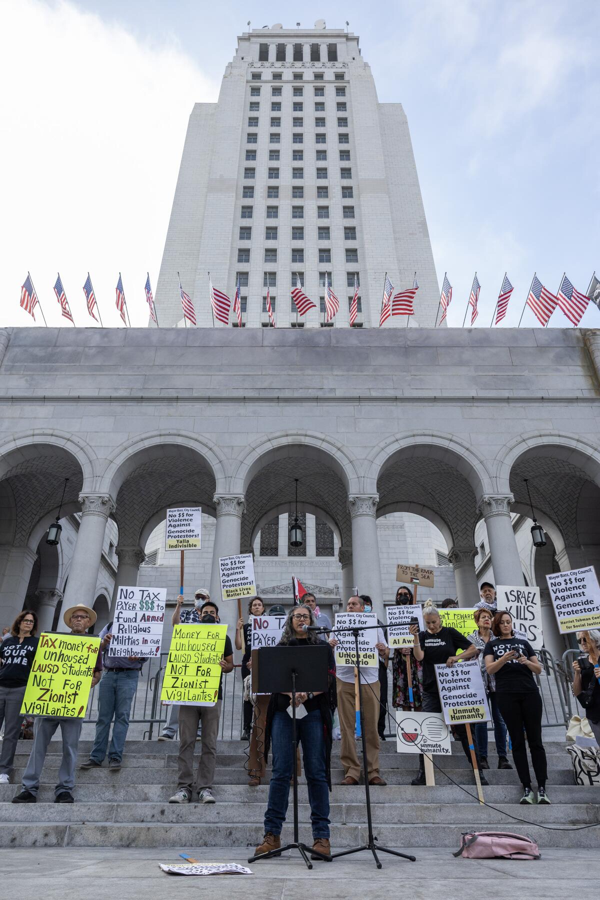 A group of speakers voice their opposition at City Hall in Los Angeles.
