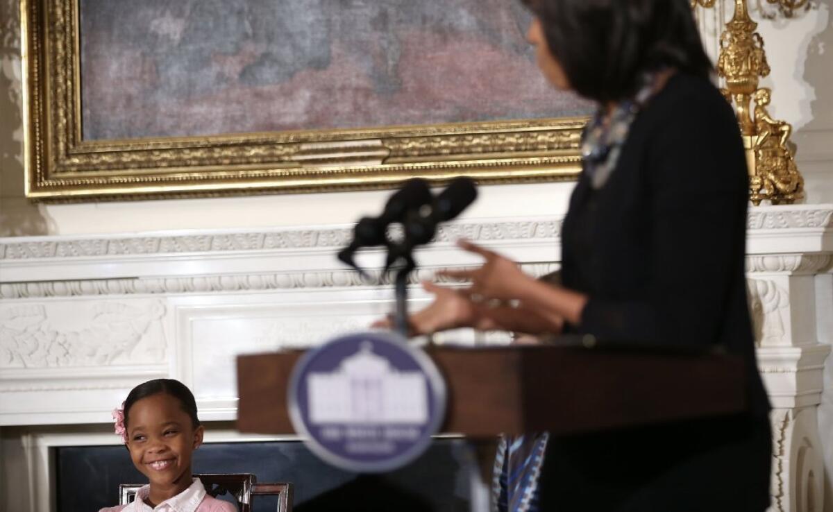'Beasts of the Southern Wild' star Quvenzhane Wallis, left, listens as First Lady Michelle Obama speaks during an interactive student workshop at the State Dining Room of the White House in Washington, D.C.