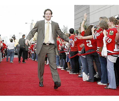 Duncan Keith greets fans on the red carpet as he arrives at the United Center for the home opener against the Predators.