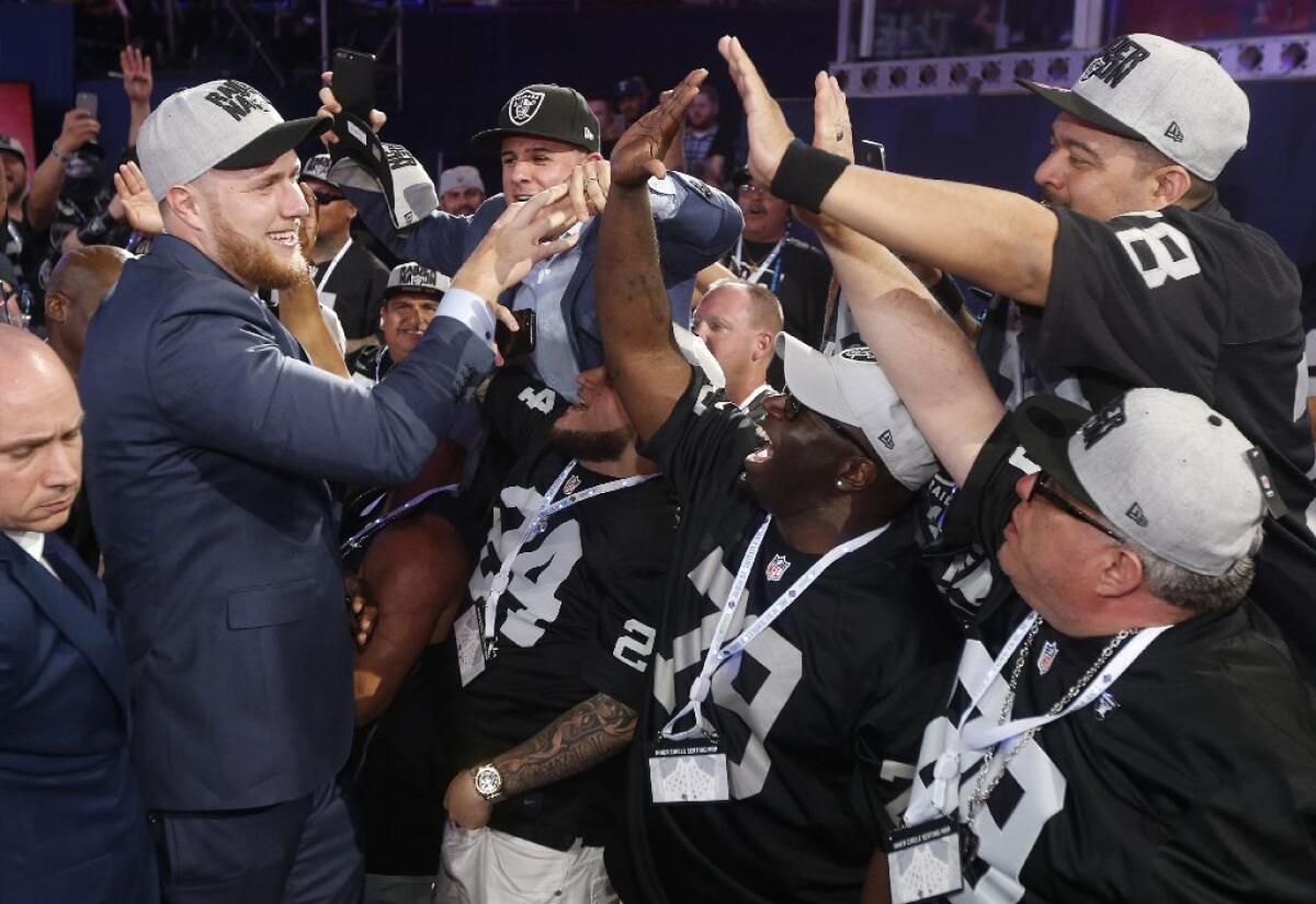 UCLA's Kolton Miller celebrates with fans after being selected by the Oakland Raiders with the No. 15 pick.