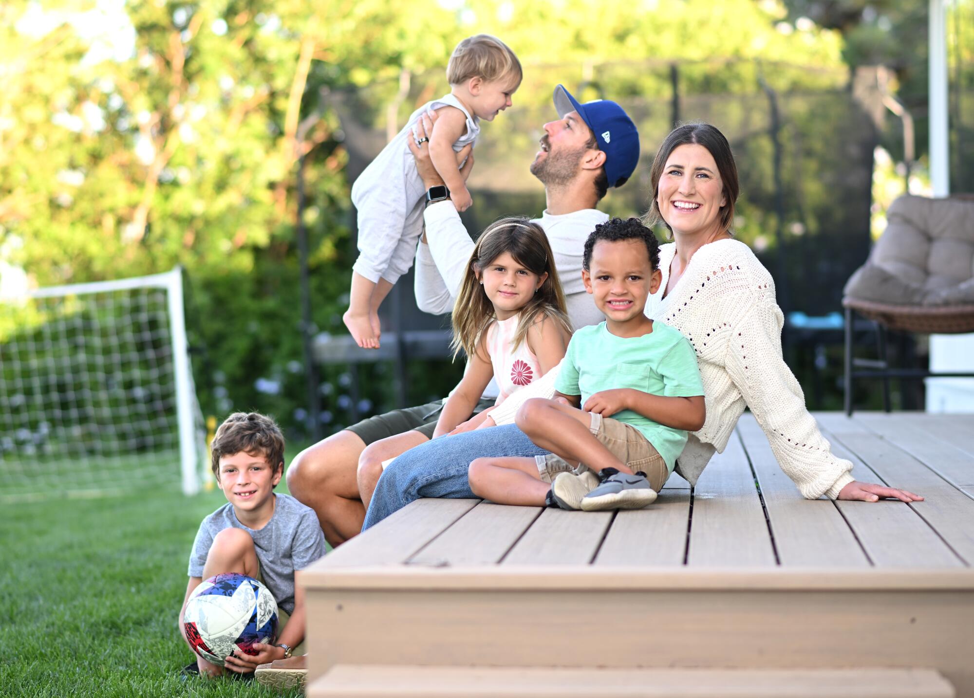 LAFC defender Ryan Hollingshead and his wife Taylor sit on their backyard deck with their children