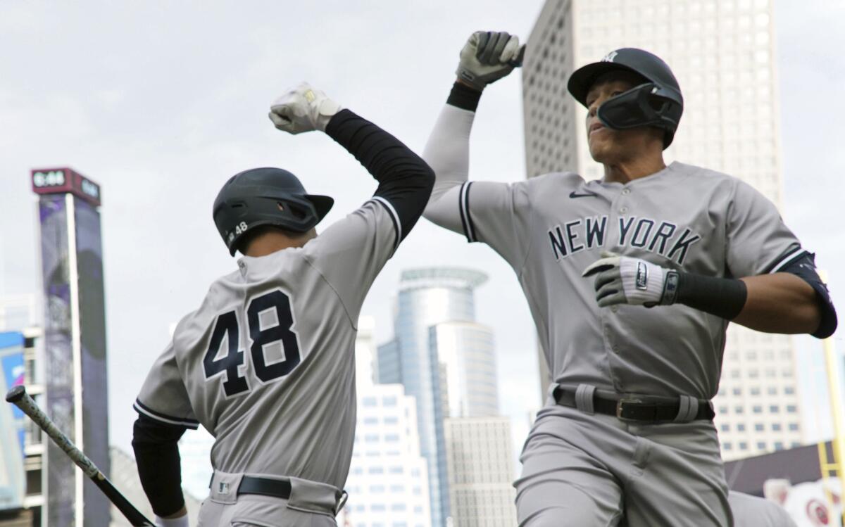 New York Yankees' Aaron Judge, right, and Anthony Rizzo celebrate a two-run home run by Judge off Minnesota Twins pitcher Cole Sands during the first inning of a baseball game Tuesday, June 7, 2022, in Minneapolis. (AP Photo/Jim Mone)