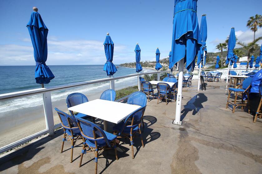 The Cliff, a popular outdoor eatery and music venue in Laguna Beach, is empty of patrons on view deck as local businesses and restaurants are being asked to avoid small gathering and uphold social distances during the widening Coronavirus pandemic.