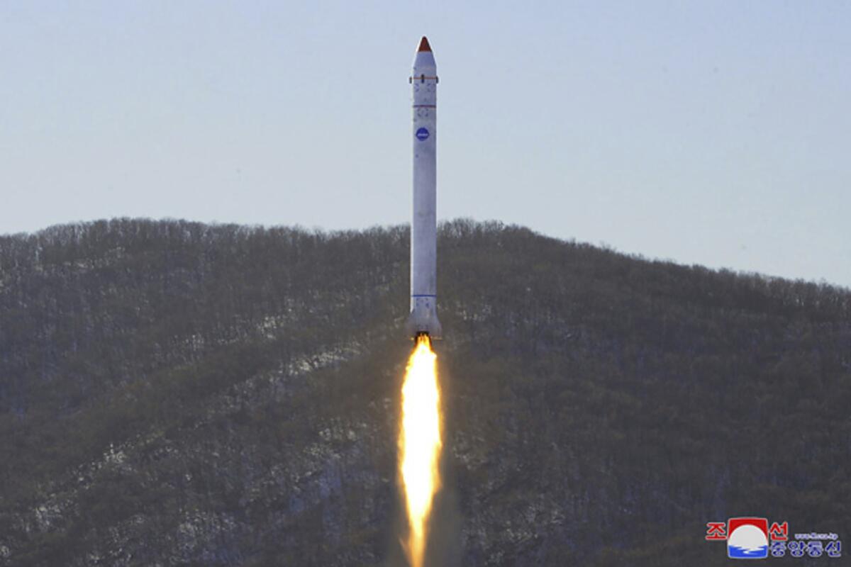 A rocket blasts off, with a mountain in the background.