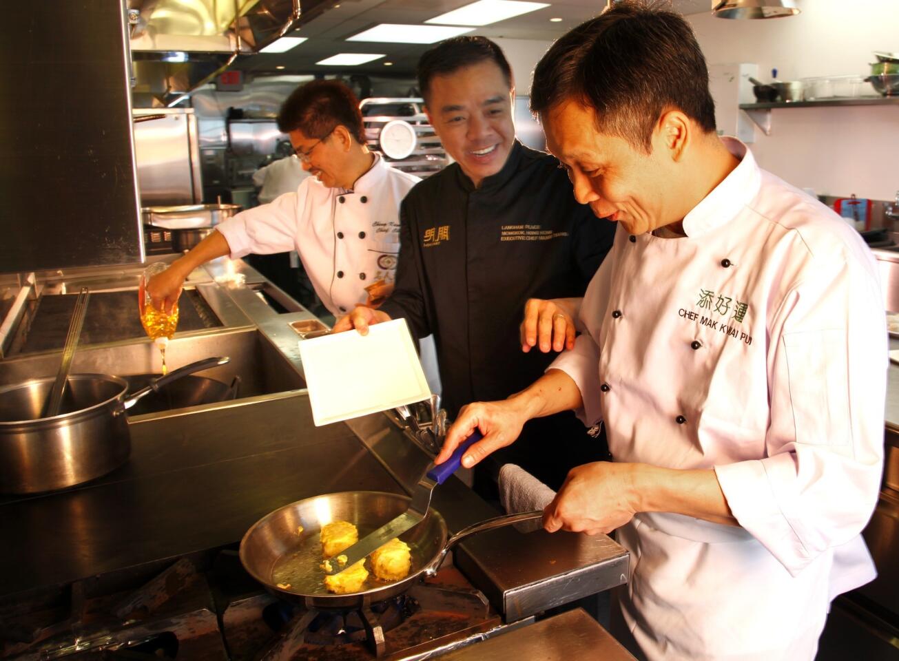 Three Michelin-rated Hong Kong Chefs, Chang Kam Fu, left, Tsang Chiu Lit and Mak Kwai Pui demonstrate their cooking techniques while they make their dishes at Lukshon in Culver City.