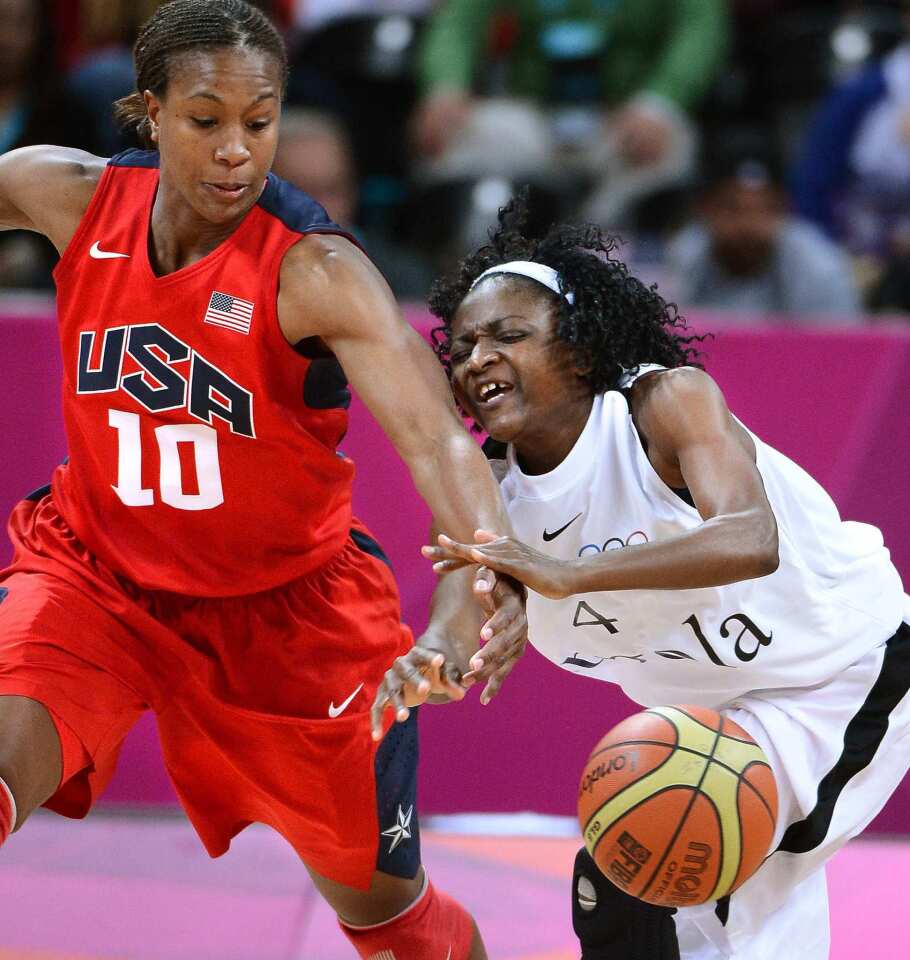 Team USA's Tamika Catchings steals the ball from Angola's Catarina Camufal.