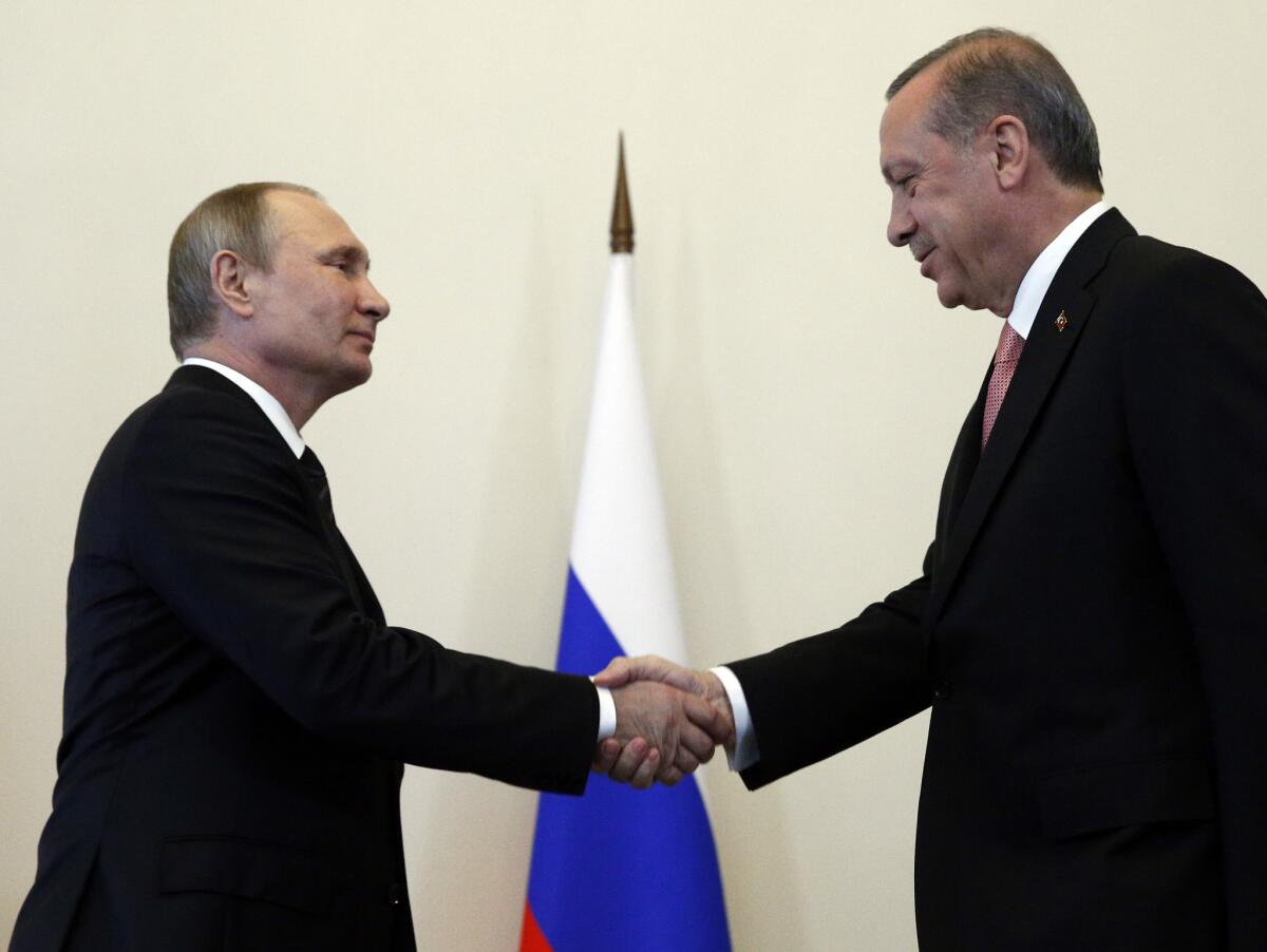 Russian President Vladimir Putin, left, welcomes Turkish President Recep Tayyip Erdogan in the Konstantin palace outside St.Petersburg, Russia, on Tuessday.