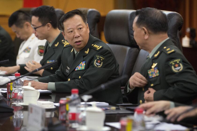 FILE - China's People's Liberation Army (PLA) Gen. Li Zuocheng, center, speaks during a meeting with U.S. Army Chief of Staff Gen. Mark Milley, not shown, at the Bayi Building in Beijing on Aug. 16, 2016. China has demanded the U.S. cease military "collusion" with Taiwan during a virtual meeting between the joint chiefs of staff from the two countries, whose relationship has grown increasingly fractious. (AP Photo/Mark Schiefelbein, Pool, File)