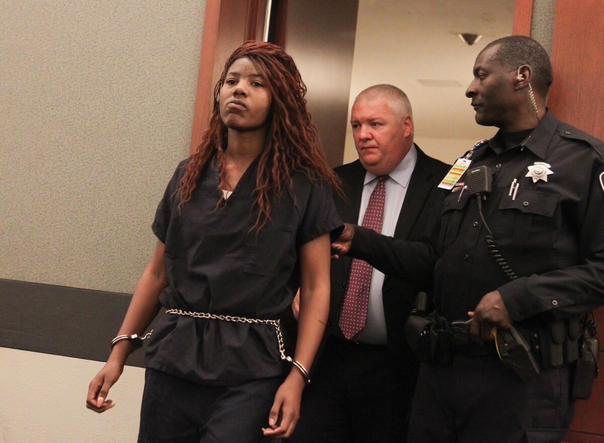 Lakeisha Nicole Holloway enters district court in Las Vegas with one of her public defenders, Scott Coffee, for her arraignment.