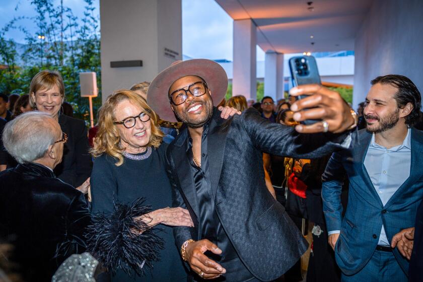 DJ D-Nice, takes a photo with Ann Philbin, left, at the 19th Annual Hammer Museum Gala.