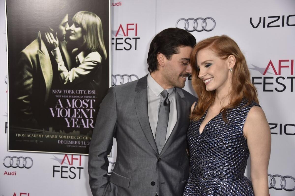 Oscar Isaac and Jessica Chastain share a moment on the red carpet for the AFI Fest gala of their film, "A Most Violent Year."