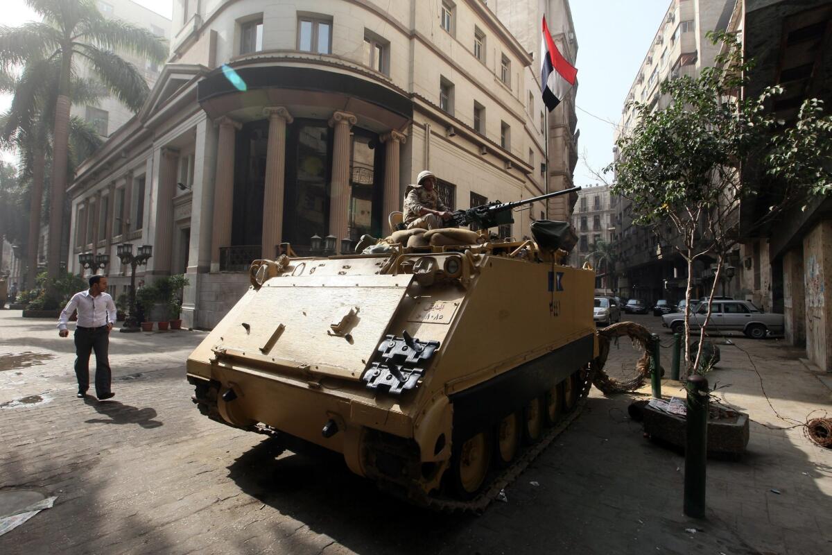 An Egyptian army armored vehicle is stationed in front of the Egyptian stock exchange in Cairo on Tuesday in advance of planned protests by supporters of ousted President Mohamed Morsi's Muslim Brotherhood. The government lifted a state of emergency that has been in place since Aug. 14.