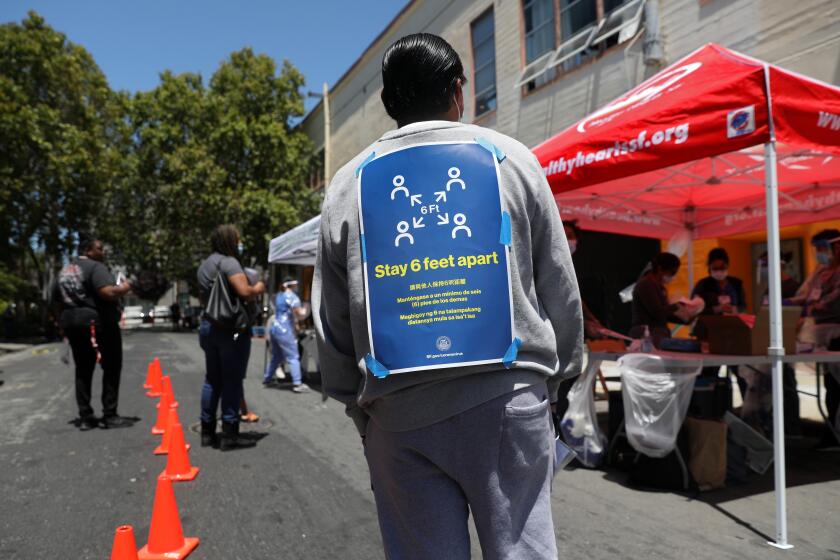 SAN FRANCISCO, CA - JULY 09: Cesar Moran, of San Francisco, waits in line to receive a Covid-19 test at a site administered by the Latino Task Force and the San Francisco Department of Public Health, at the Mission Language and Vocational School in the Mission District on Thursday, July 9, 2020 in San Francisco, CA. University California San Francisco new study shows economic factors fueled COVID-19 transmission in Latino essential workers and families despite shelter-in-place in the Mission District. (Gary Coronado / Los Angeles Times)