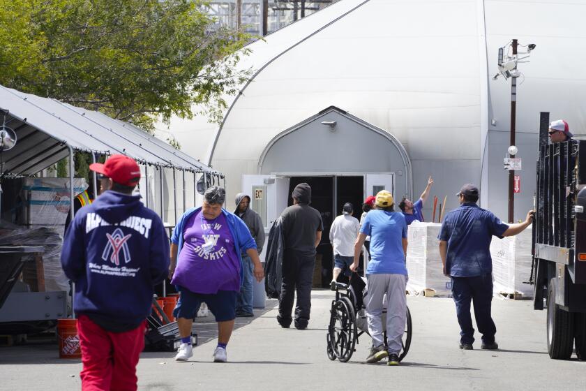 San Diego, CA - May 08: On Wednesday, May 8, 2024, in San Diego, CA, at the shelter operated by the Alpha Project, folks living on the street and staff members return to the shelter on Newton Avenue and 16th Street. (Nelvin C. Cepeda / The San Diego Union-Tribune)