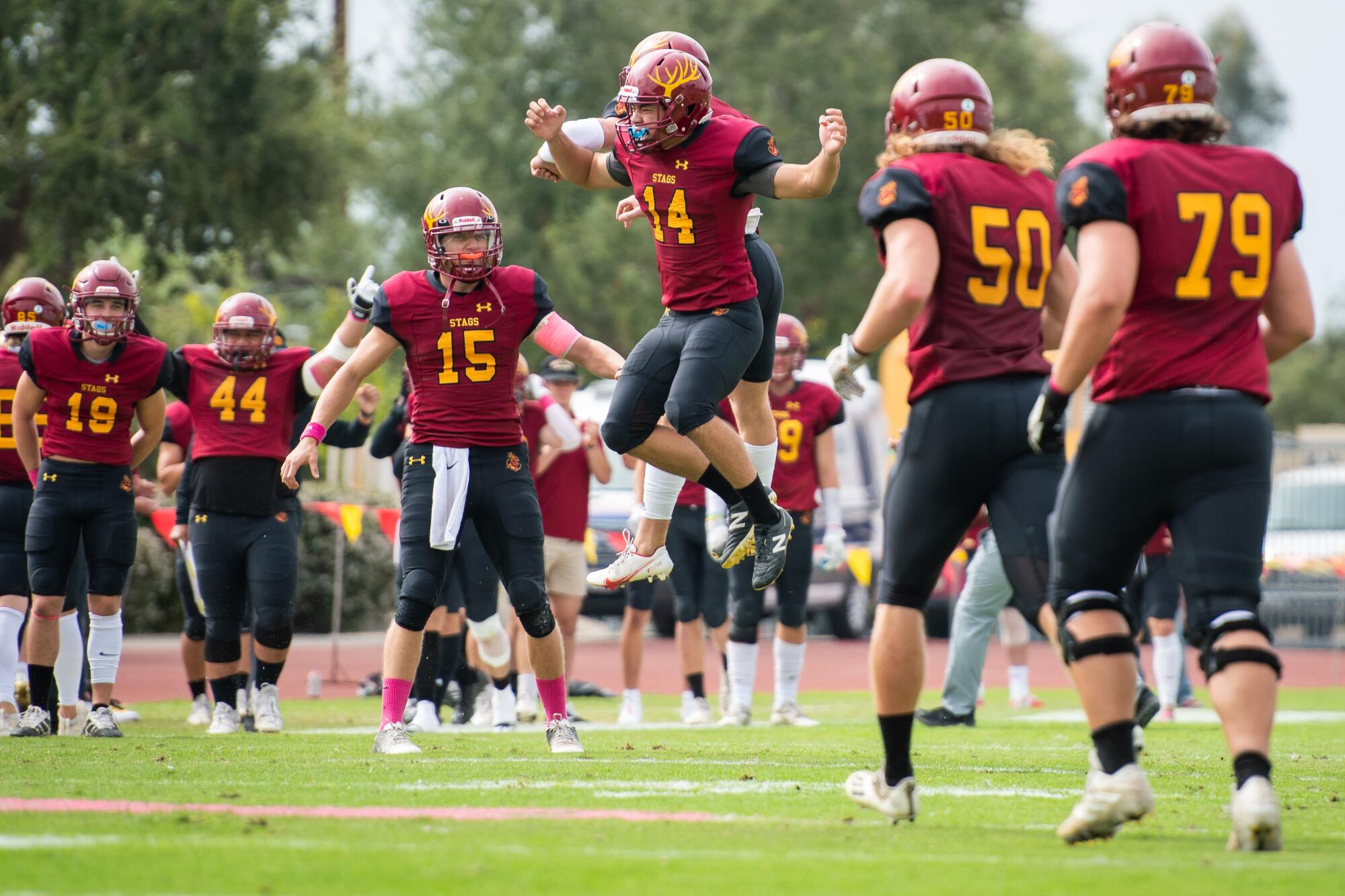 Claremont-Mudd-Scripps kicker Alessandro Maiuolo jumps in the air and celebrates with teammates after a 54-yard field goal.