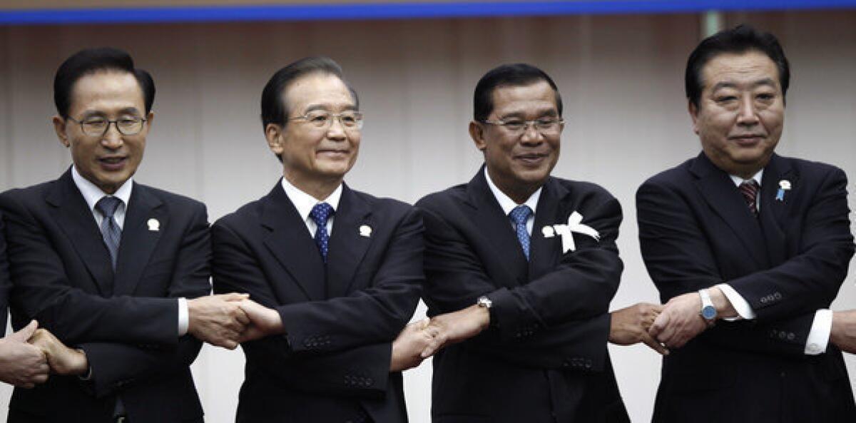At the Assn. of Southeast Asian Nations summit in Cambodia last month, from left, South Korean President Lee Myung-bak, Chinese Premier Wen Jiabao, Cambodian Prime Minister Hun Sen and Japanese Prime Minister Yoshihiko Noda struck an amicable pose despite sharpening disputes over resource-rich islands along the East Asian coast. New leaders chosen since then in China, Japan and South Korea show no signs of putting the divisive territorial squabbles behind them.