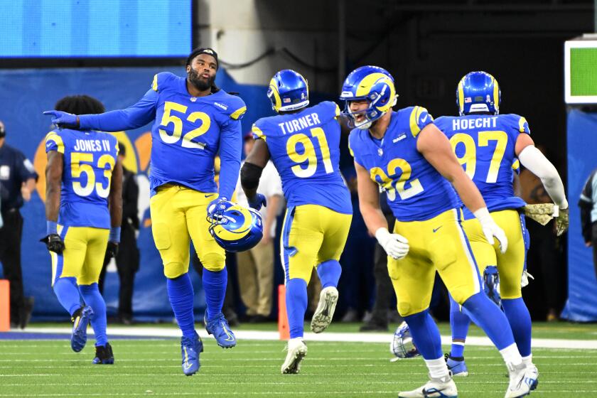 The Rams celebrate a missed field goal by Seattle after a stop by the defense.