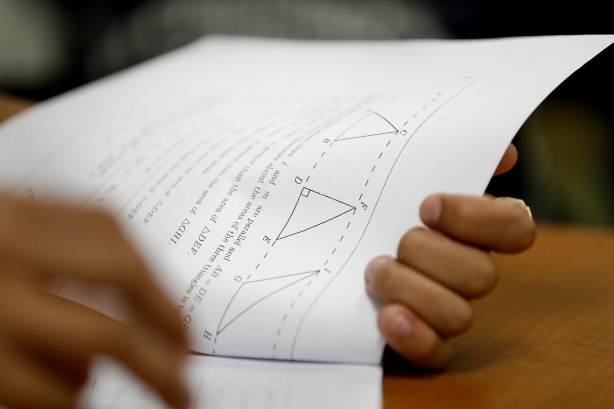 A 12th-grade student studies from a math workbook at Roybal Learning Center in Los Angeles. 