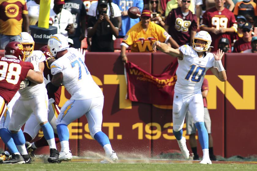 Los Angeles Chargers quarterback Justin Herbert (10) makes a throw during an NFL football game against the Washington Football Team, Sunday, Sept. 12, 2021 in Landover, Md. (AP Photo/Daniel Kucin Jr.)