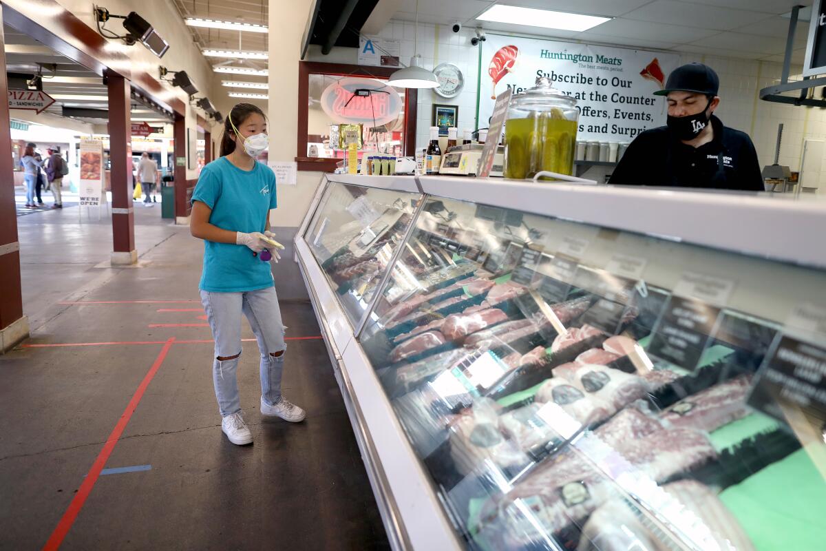  shops for a client at Huntington Meats at the Original Farmers Market on Wednesday, 