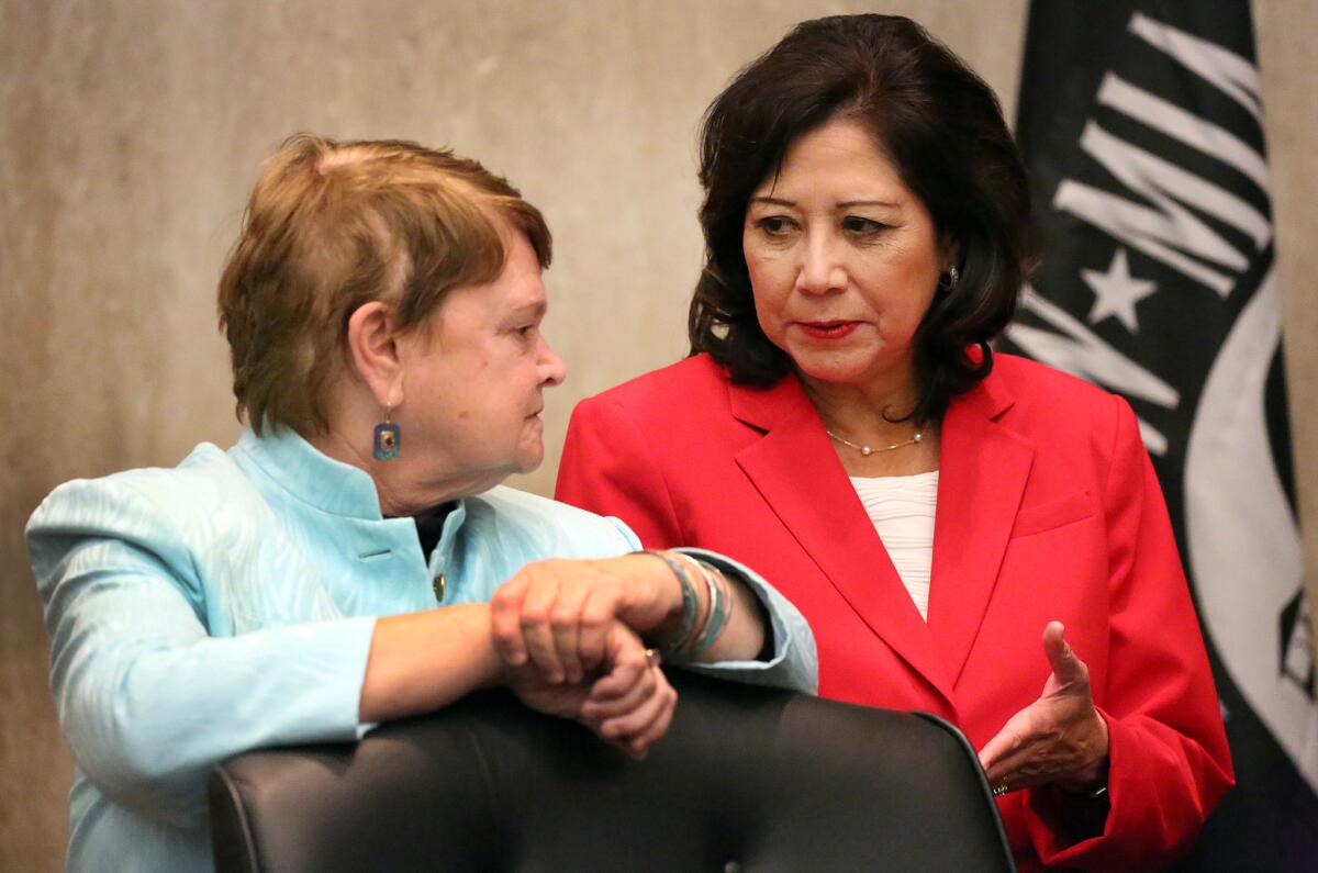 The L.A. County Board of Supervisors on Tuesday approved a ban on travel to North Carolina by county employees in response to the state's law restricting the bathrooms that transgender people can use in public facilities. Supervisors Sheila Kuehl, left, and Hilda Solis, seen in 2015, backed the travel ban.
