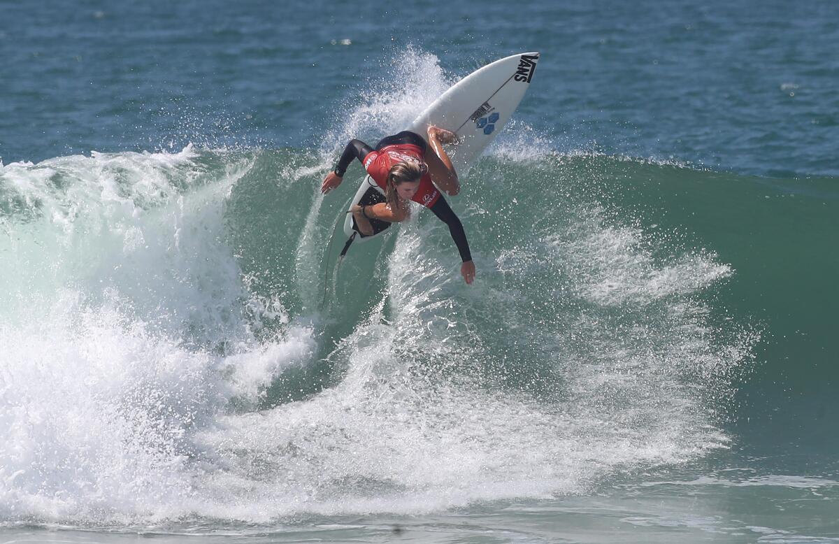 Local girl Bella Kenworthy of San Clemente competes in the U.S. Open of Surfing at the Huntington Beach Pier on Friday.