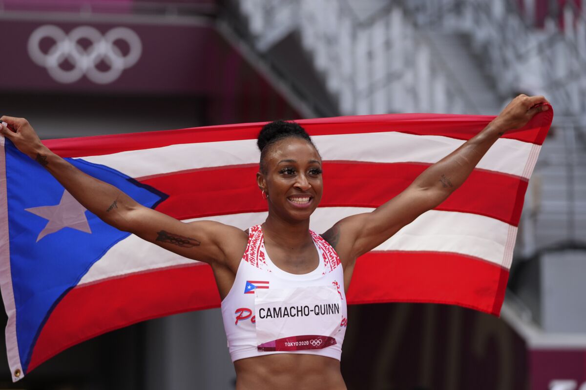 FILE - Jasmine Camacho-Quinn, of Puerto Rico, celebrates after winning the women's 100-meter hurdles final at the 2020 Summer Olympics, Monday, Aug. 2, 2021, in Tokyo. She's already a celebrity in Puerto Rico. Her name appeared on billboards after her win in Tokyo. She had a parade in her honor and met some of the country's biggest names. She appreciated all the attention but now is eager to get back to work of winning more gold medals. (AP Photo/Matthias Schrader, File)