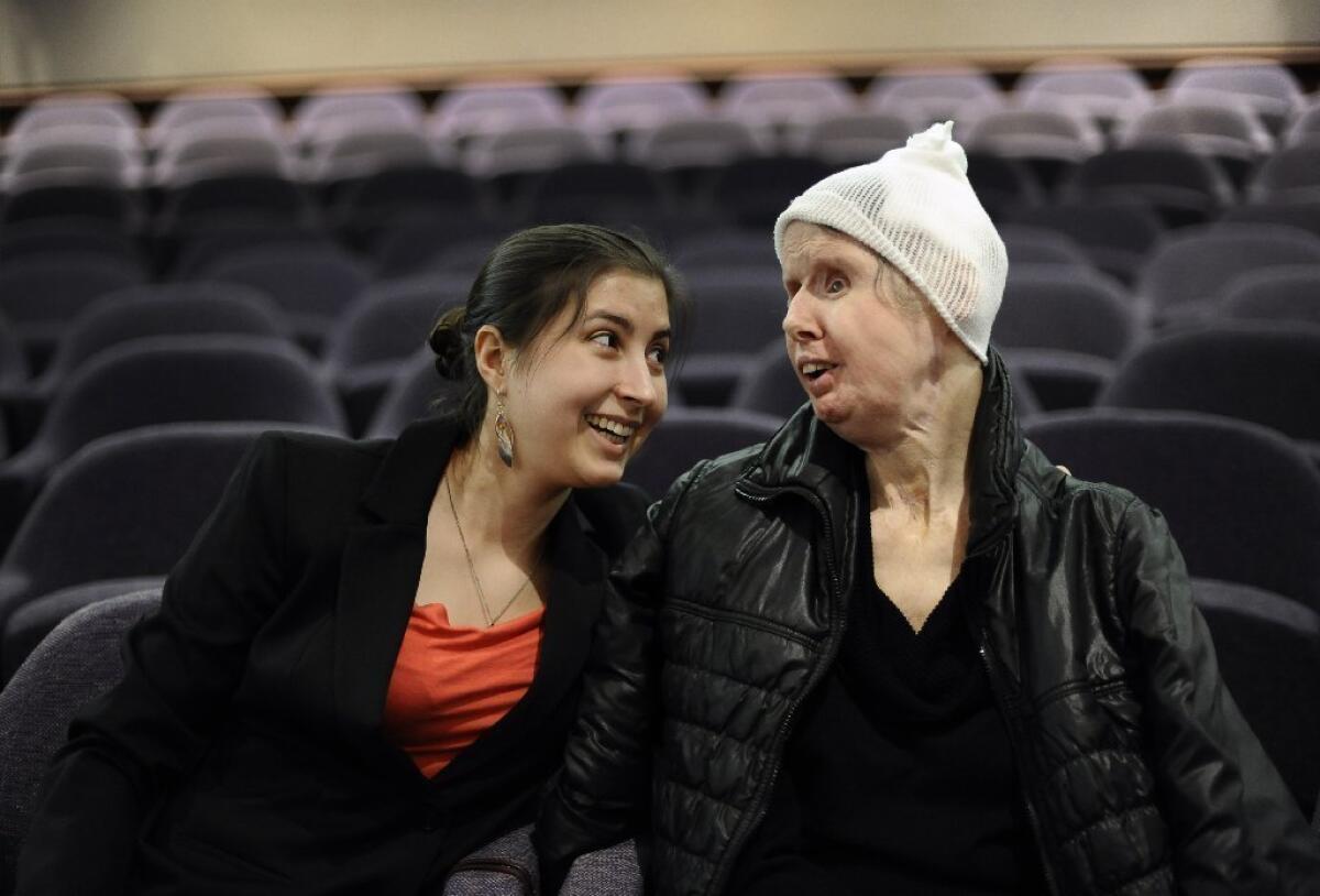 Charla Nash, right, sits with her daughter, Briana, before testifying before lawmakers in Connecticut last month. Nash was seeking the right to sue the state for damages after her 2009 attack by a friend's chimpanzee, who tore off Nash's face and hands.