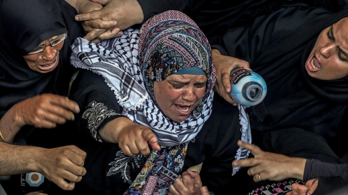 Relatives mourn Saturday at the funeral for Razan Najjar, a Palestinian volunteer paramedic who was shot dead by Israeli soldiers on Friday in the Gaza Strip.