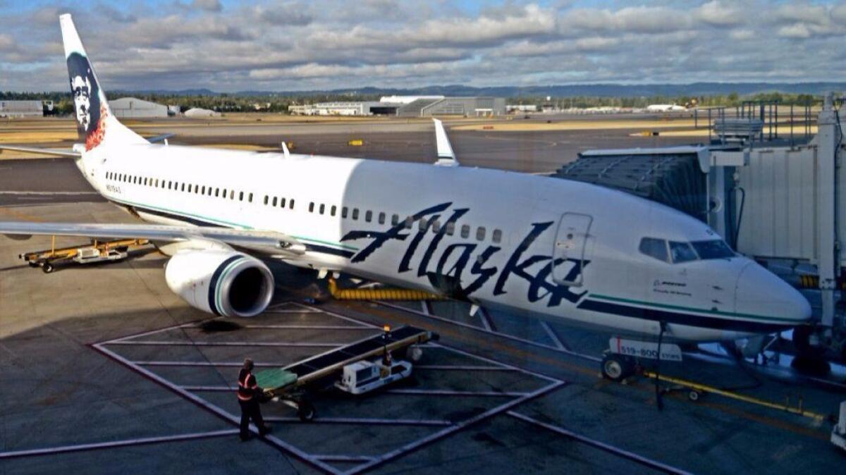 Alaska Airlines has cut its fees for checking most sports equipment, such as bicycles and golf clubs, to $25 from $75. Above, an Alaska jet in Portland, Ore.