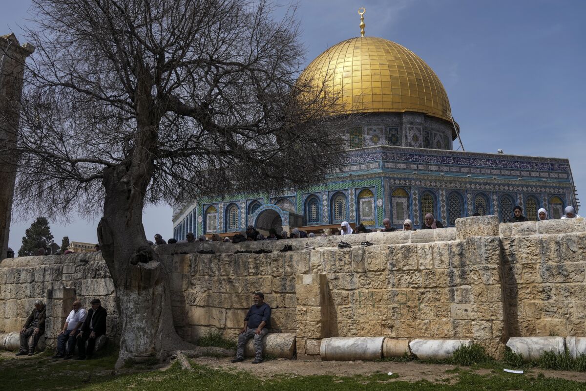 Muslim worshippers gather for Friday prayers, next to the Dome of the Rock Mosque in the Al Aqsa Mosque compound in Jerusalem's old city, Friday, April 1, 2022. (AP Photo/Mahmoud Illean)