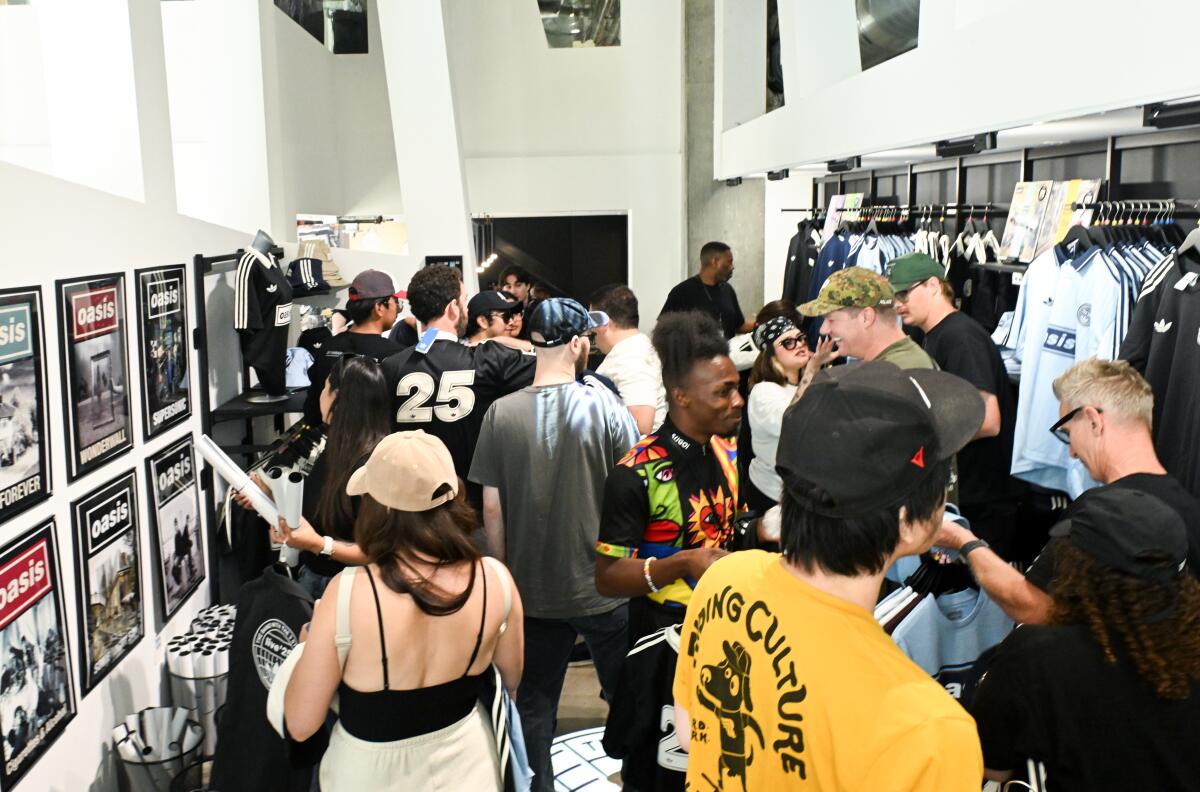 Oasis fans pour into the band's merch shop weeks before the Gallagher brothers are set to take the stage at the Rose Bowl.