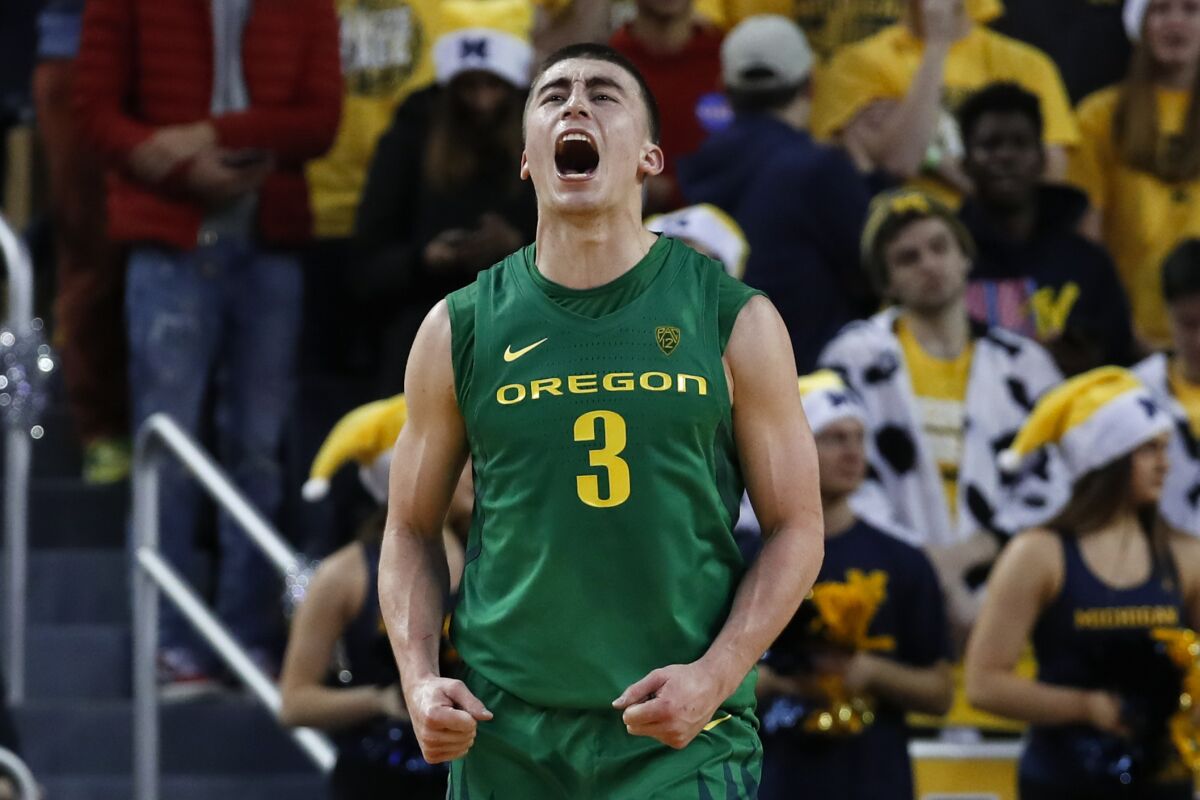 Oregon guard Payton Pritchard celebrates a basket against Michigan during the overtime of a game Dec. 14.