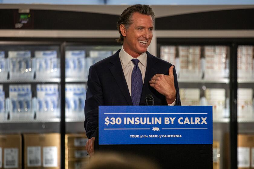 Downey, CA - March 18: Standing infant of refrigerators filled with insulin California Governor Gavin Newsom announces that the state has landed a contract with a company to produce insulin during a press conference at Kaiser Permanente Pharmacy on Saturday, March 18, 2023, in Downey, CA. His plan for a state-run insulin program is part of Newsom's broader agenda to reduce health care costs for Californians. (Francine Orr / Los Angeles Times)