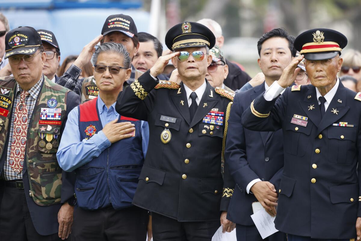 Korean and Vietnam war veterans saluting