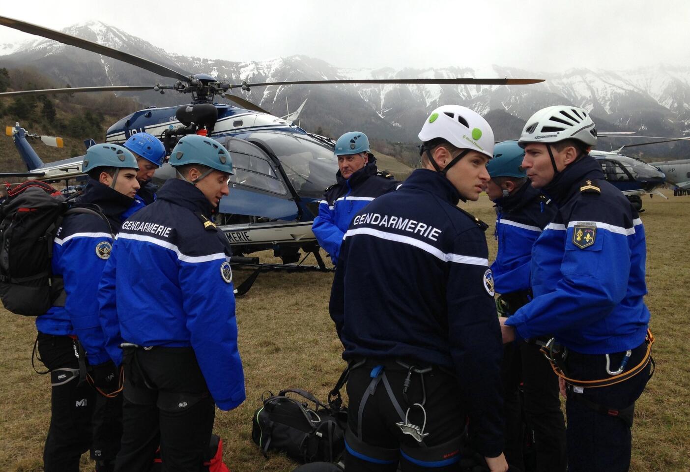 Members of the Gendarmerie, a French police force, and mountain rescue teams arrive near the site of the Germanwings plane crash in the French Alps near La Seyne.