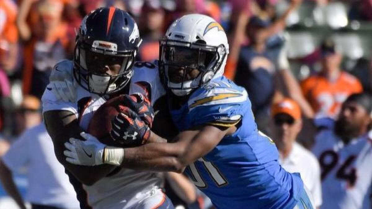 Denver Broncos wide receiver Demaryius Thomas, left, is tackled by Chargers strong safety Adrian Phillips during the second half.