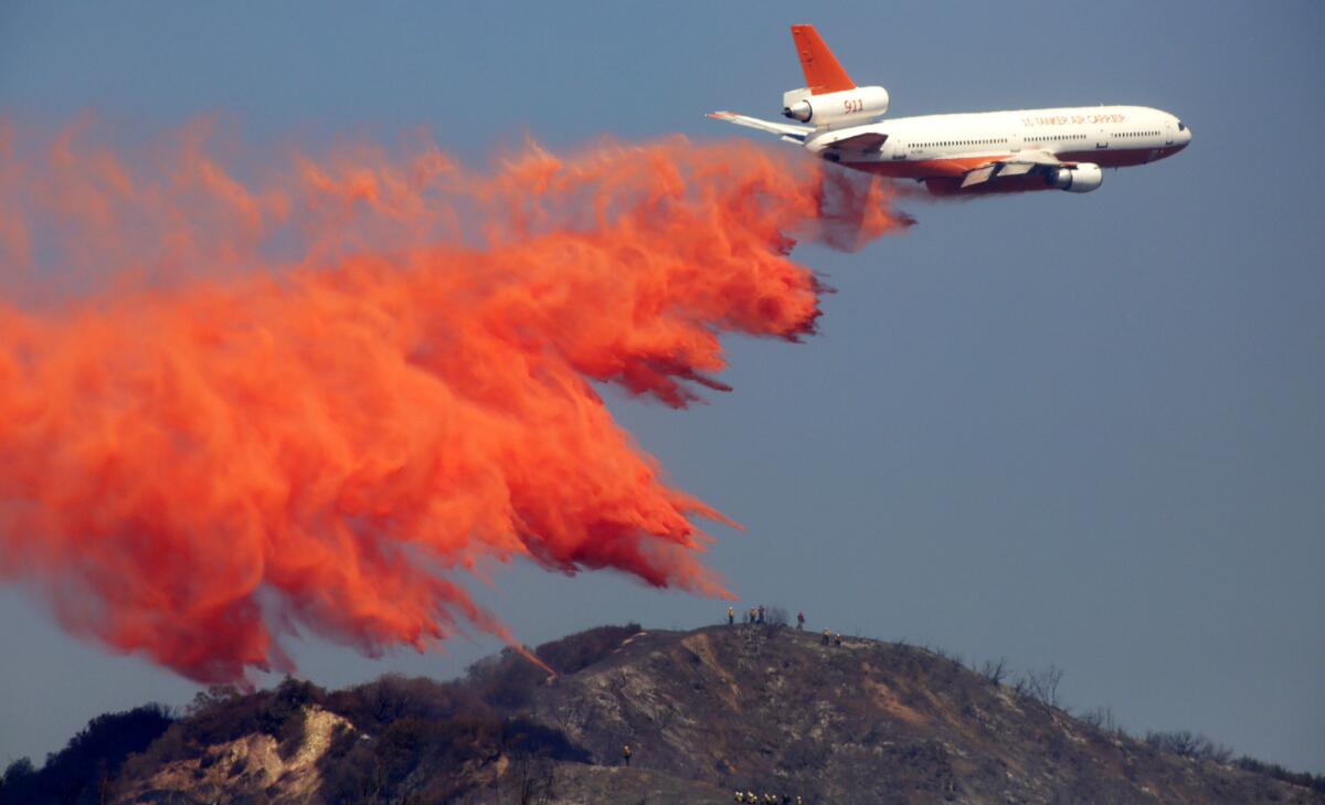 A DC-10 firefighting airplane drops retardant on the Madre fire in the Angeles National Forest above Azusa.